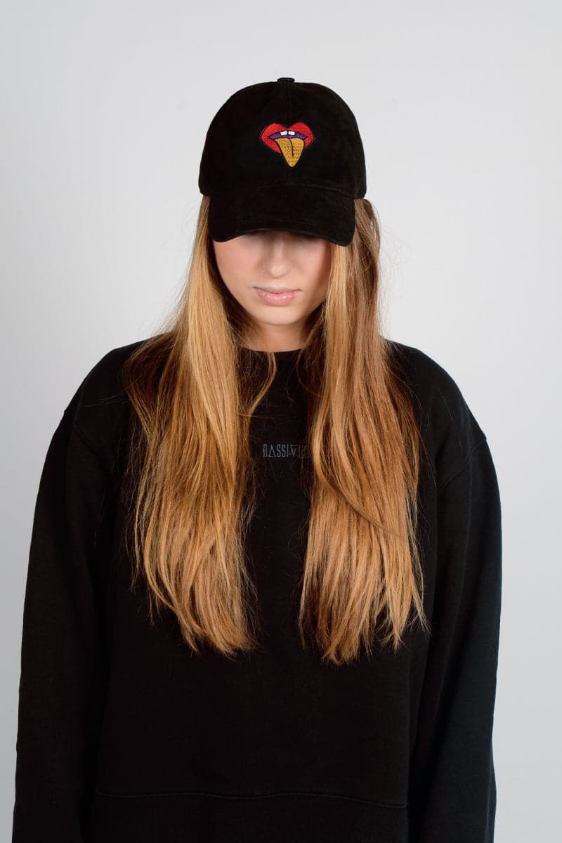 Black Bassigue rolling tongue embroidered cap with adjustable fit, casual hat featuring colorful embroidered tongue design.