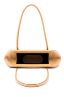 Behnо New York Elizabeth Baguette mini pebble leather top handle bag in peach, showing interior view with stitching and compartments.