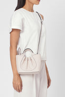 Behnō New York Katrina Mini Tote Pebble in Pumice shoulder bag with soft pebble texture, worn on body for casual style.
