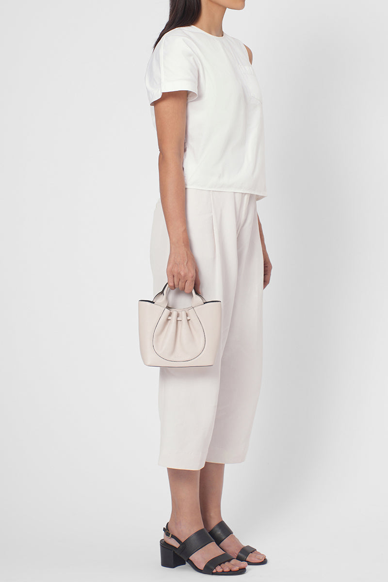 Behn New York Katrina Mini Tote Pebble in Pumice, a stylish shoulder bag with a textured pebble finish, shown on model.