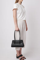 Black pebble leather shoulder bag from behno New York, featuring a sleek design and modern style.