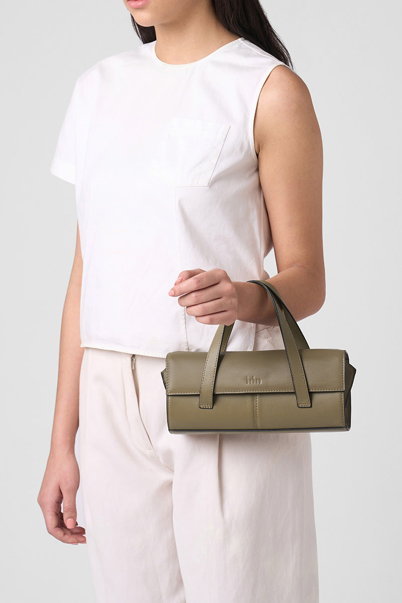 Behno New York Michelle mini crossbody bag in nappa palm leather, shown worn on the body, with top handle design and textured finish.