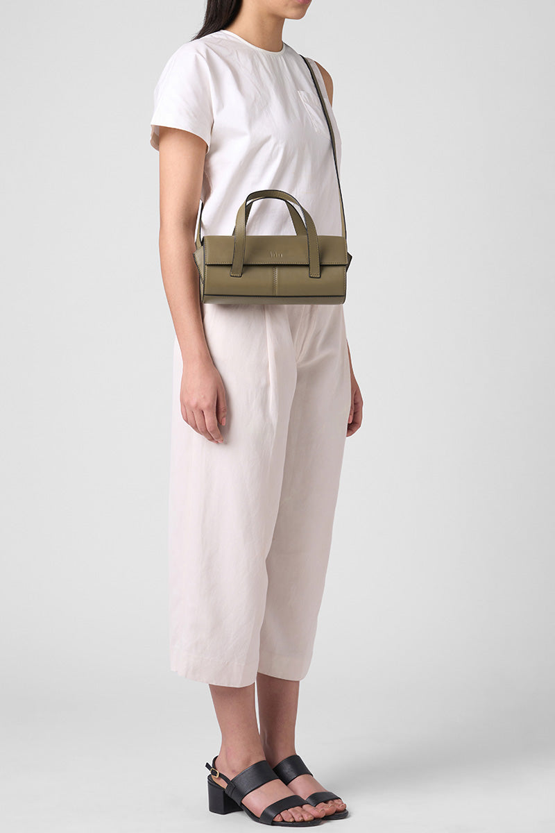 Behno New York Michelle mini crossbody bag in nappa palm leather, shown on body with top handle design.