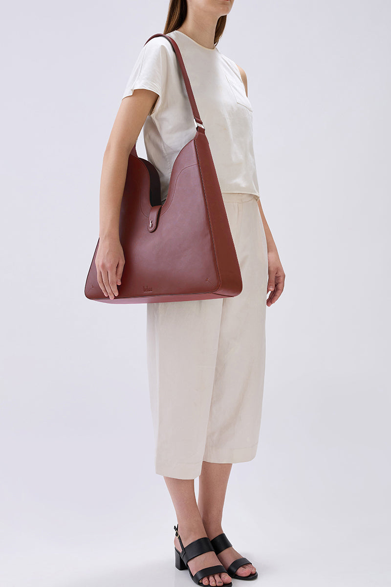 Behno New York Melina shoulder bag in Nappa leather, brick color, featuring a sleek, structured design with a top handle and shoulder strap.