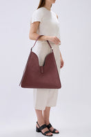 Behno New York Melina shoulder bag in rich nappa brick leather with sleek design and adjustable shoulder strap.