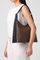 Large canvas shoulder bag by behno New York, featuring a cacao and black design with a sleek, modern look.