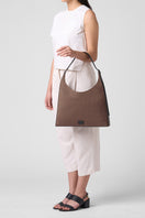 Large canvas shoulder bag by behno New York in cacao and black, featuring a sleek, spacious design with a comfortable shoulder strap.