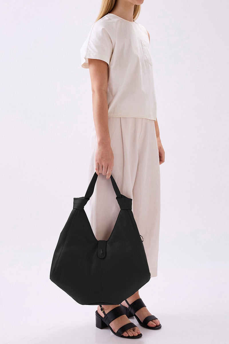 Large NELLI HOBO Pebble Shoulder Bag in black by behno New York, shown on body with soft pebble texture and spacious design.