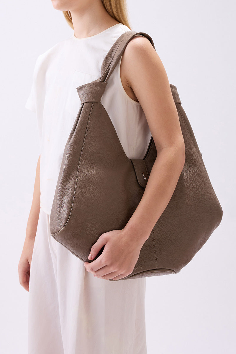 Large taupe Nelli Hobo shoulder bag by behno New York with pebble leather texture, featuring a slouchy, casual design.