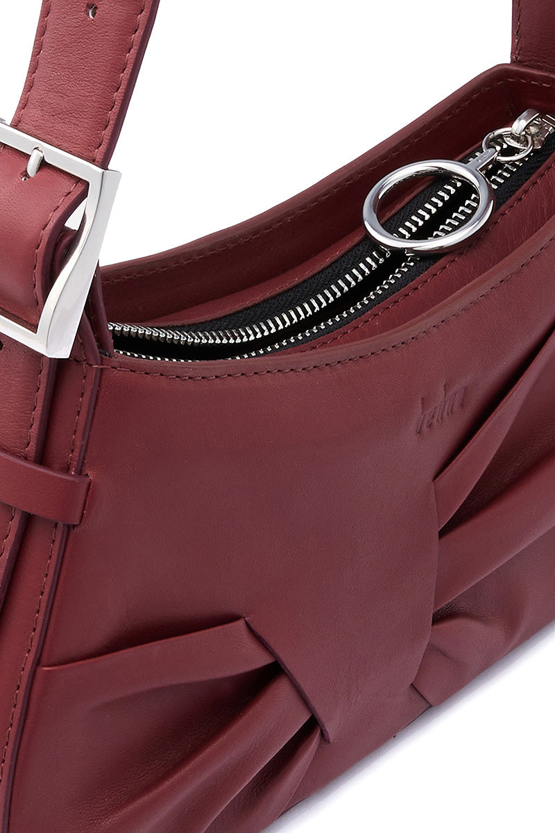 Behn New York Leena Mini Shoulder Bag in brick-colored nappa leather with draped design and compact silhouette.
