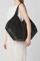 Behno New York Safra Pebble Tote in black, stylish shoulder bag shown on model with textured pebble leather finish.