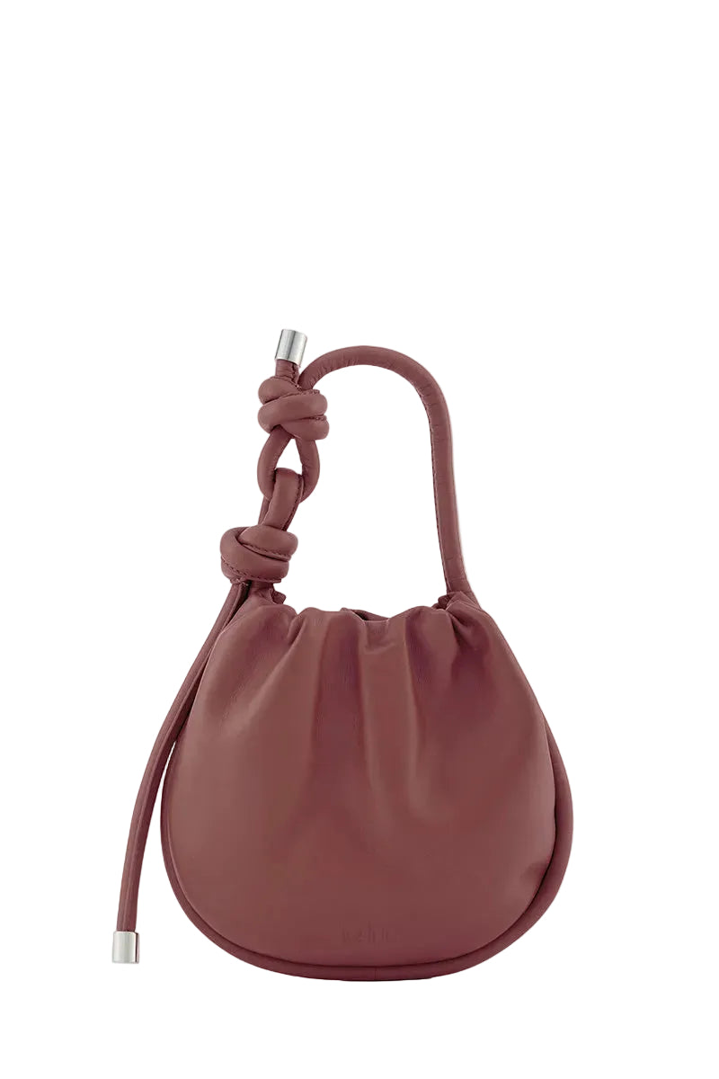 Behn0 New York INA Mini Potli Nappa Brick top handle bag with a sleek brick-colored leather exterior and elegant design.