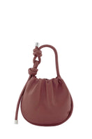 Behno New York INA Mini Potli Nappa Brick top handle bag with a sleek design and top handle, showcasing the brick-colored leather.
