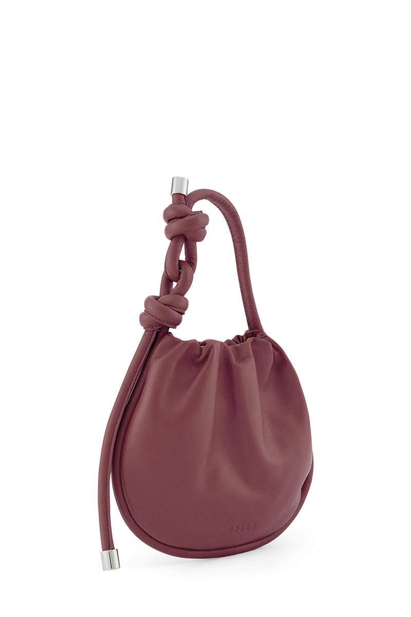Behno New York INA Mini Potli Nappa Brick top handle bag with a sleek brick-colored leather finish.