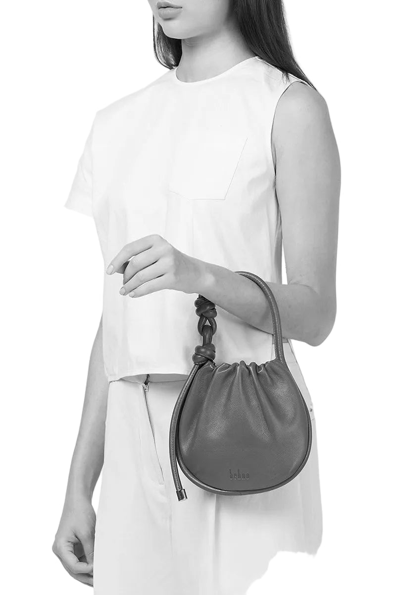 Behno New York INA MINI POTLI NAPPA BRICK top handle bag with a structured design and top handle in a rich brick color.
