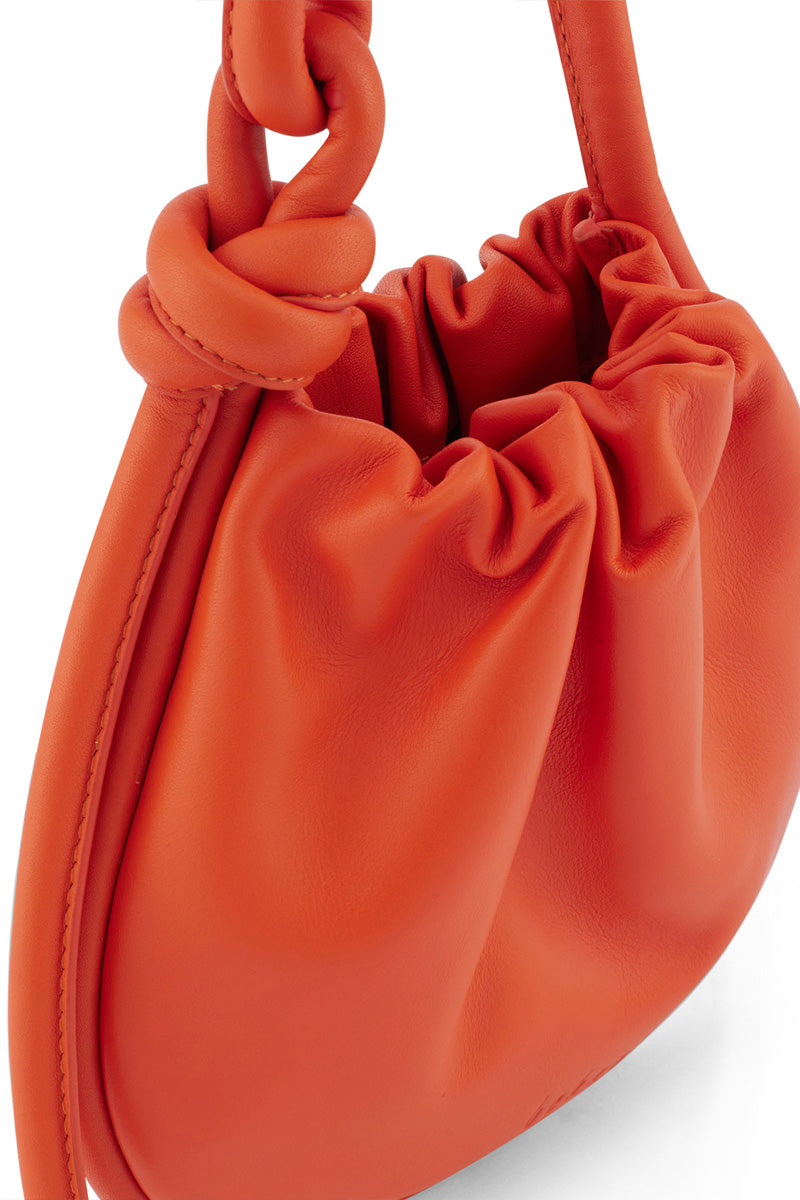 Behno New York INA MINI POTLI NAPPA Carrot top handle bag with vibrant orange leather and detailed craftsmanship.