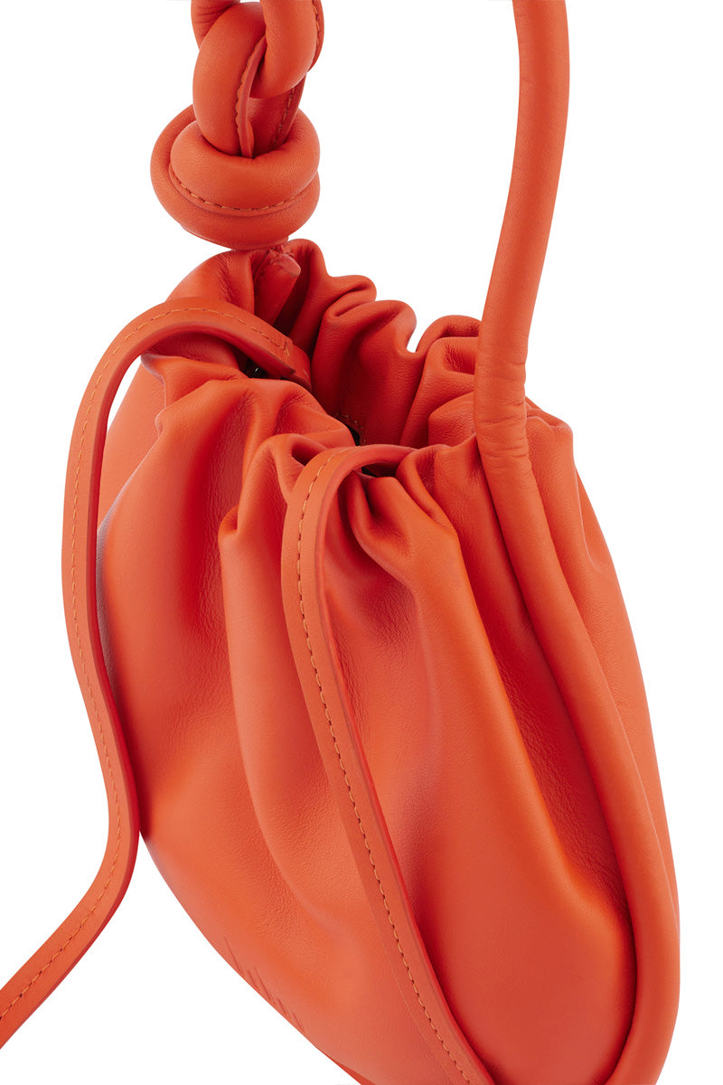 Behno New York INA Mini Potli Nappa Carrot top handle bag with a vibrant orange color and elegant design, ideal for stylish occasions.
