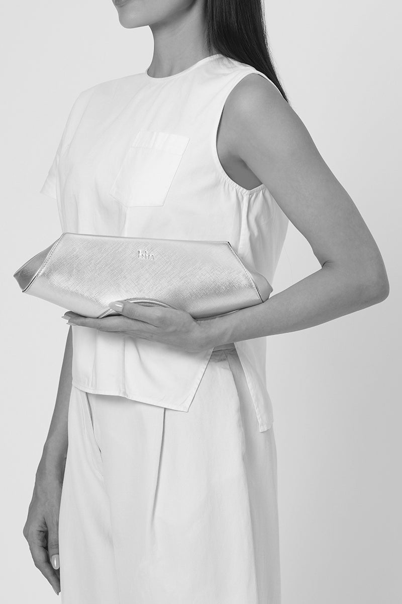 Gold Elizabeth Baguette Mini Clutch by behno New York, featuring a sleek, compact design with a smooth finish.
