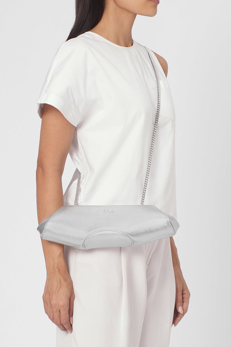 Silver Elizabeth Baguette Mini Clutch by behno New York, showcasing sleek, compact design with a smooth metallic finish.