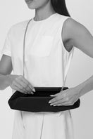 Behnio New York Elizabeth Baguette Mini Clutch in hematite with sleek, metallic finish and compact design, shown on body.