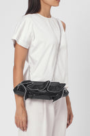 Black Elizabeth Baguette Mini Clutch by Behno New York with ruffle silk and crinkle texture, on-body shot.