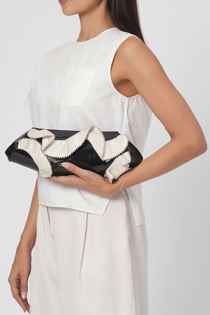 Behnò New York Elizabeth Baguette Mini Clutch in crinkled silk with ruffle detail, in pumice and black colors, on body view.