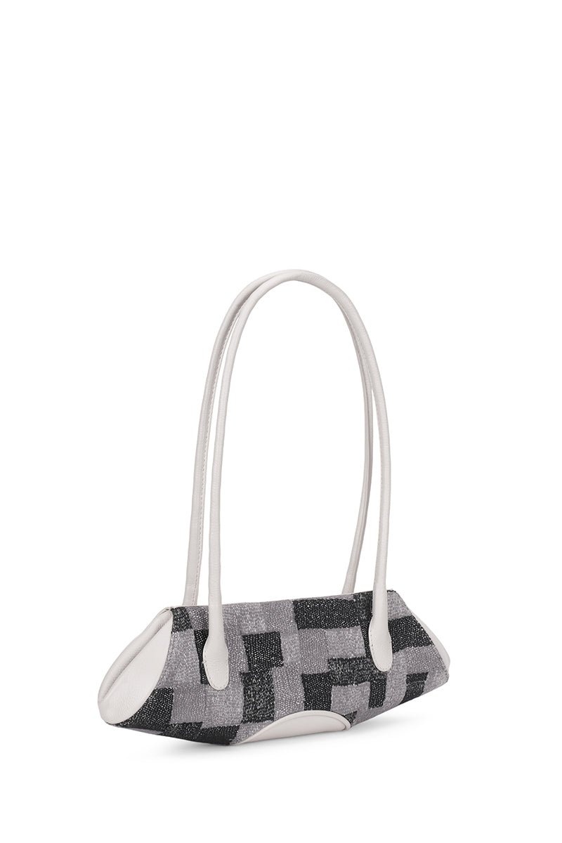 Behn0 New York Elizabeth Baguette Mini top handle bag in Pumice with Kantha silk and pebble details, showing side view.