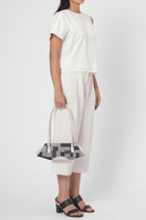 Behn0 New York Elizabeth Baguette Mini top handle bag in Kantha silk and pebble Pumice color, shown on a model.