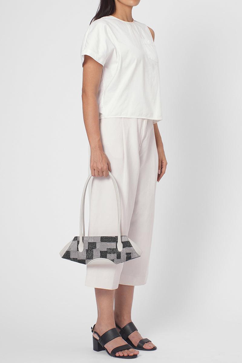 Behn0 New York Elizabeth Baguette Mini top handle bag in Kantha silk and pebble Pumice color, shown on a model.