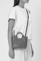 Black Katrina Mini Tote shoulder bag by behno New York, featuring python and nappa leather with on-body view.