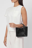 Black crinkle leather Katrina Mini Tote No2 shoulder bag by behno New York, shown on body with sleek design and compact size.