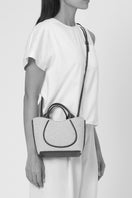 Behno New York Katrina Mini Tote in boucle wool and nappa leather in pumice and black, shown on body with shoulder strap.