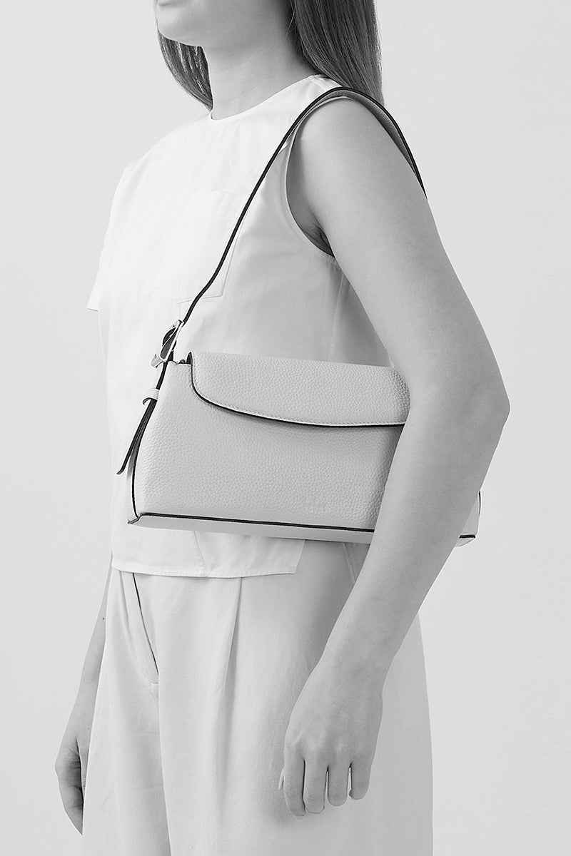 Black Yara Baguette Crinkle top handle bag by behno New York shown on body, featuring textured crinkle leather and elegant design.