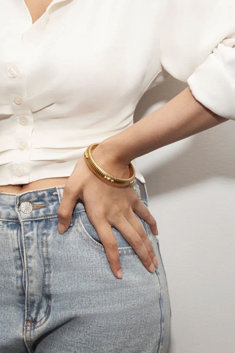 Thin gold-plated bangle bracelet by Ben Amun, featuring a sleek, minimalist design in shiny gold finish.