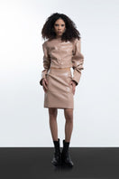 Beige faux leather cropped blazer by Blikvanger, shown in size XXS with lapel collar and stylish tailored fit.