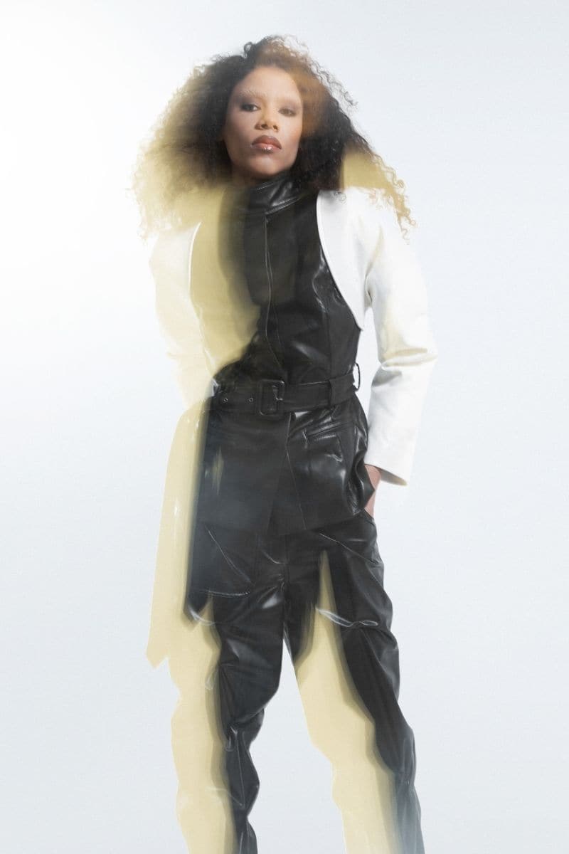 Black and white blazer jacket by Blikvanger, tailored fit, showing front view with collar and button details.