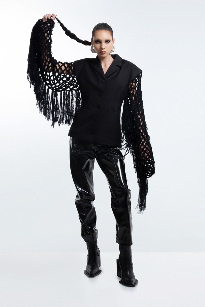 Black fishnet-sleeve blazer by Blikvanger, featuring a tailored fit and stylish fishnet detail on the sleeves.