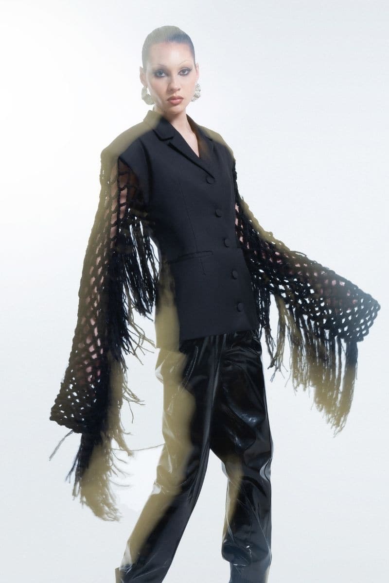 Black fishnet-sleeve blazer by Blikvanger, stylish fitted blazer with sheer fishnet sleeves, black color, size XXS.