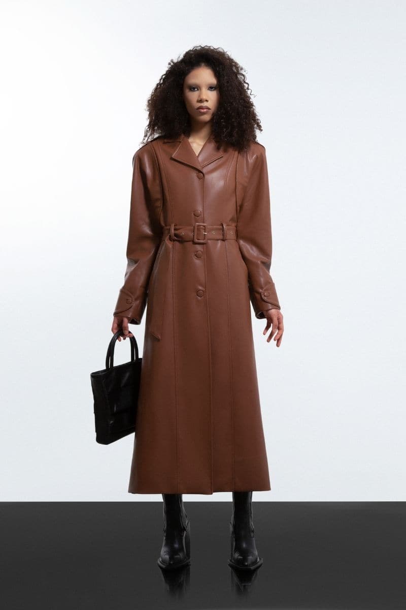 Brown faux leather long coat by Blikvanger, featuring a stylish and sleek design, shown in a close-up view.