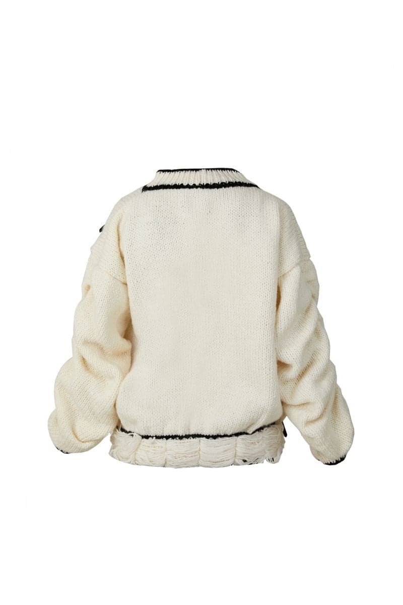 Cream-colored Blikvanger knitted sweater featuring a cake pattern, displayed on a white background.