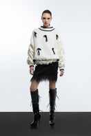 White Blikvanger cream cake knitted sweater with a cozy, textured knit pattern, shown on a mannequin in XXS size.