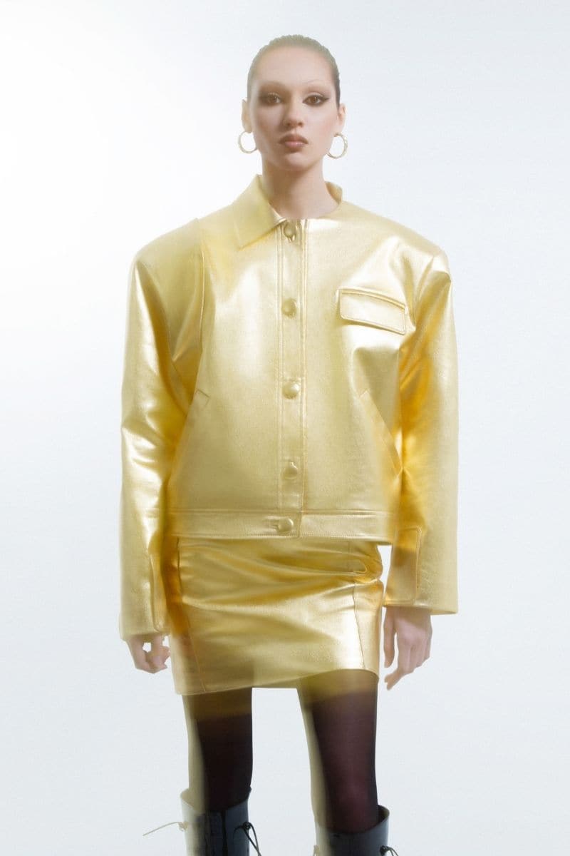 Golden faux leather jacket by Blikvanger, shown in XXS size, featuring a sleek and stylish design with a smooth leather-like finish.