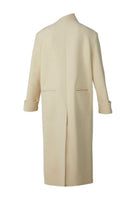 Milky white long coat by Blikvanger, showcasing a stylish and elegant coat with a tailored fit and button details.