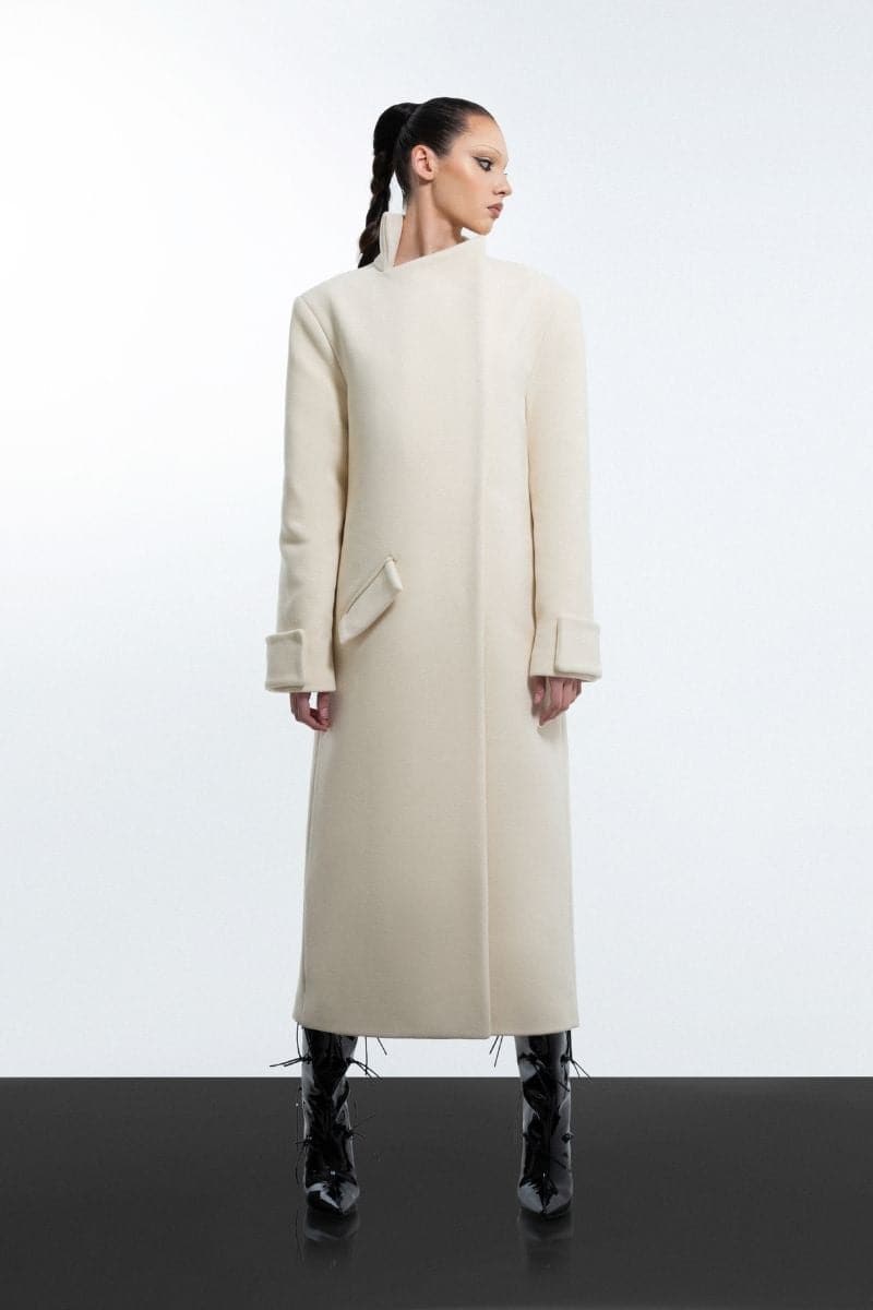 Milky white long coat by Blikvanger, shown on a mannequin, featuring a sleek design and full-length style.