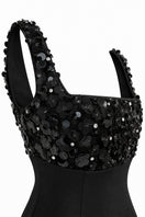 Black BLOOME mini dress by URBAN MUSE, featuring a stylish and fitted design, shown on a model.