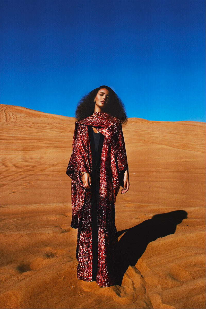 Brown Bordeaux kimono maxi dress by Amel Batita featuring flowing fabric and elegant design, shown on a model in a campaign setting.