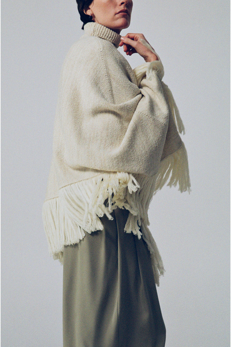 Cream-colored milk blush cardigan from DELEGAN, featuring a cozy, soft knit fabric and a relaxed fit for stylish comfort.