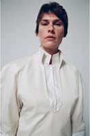 Gray-beige structured shirt by DELEGAN, featuring a tailored fit and modern design, displayed in a fashion campaign image.