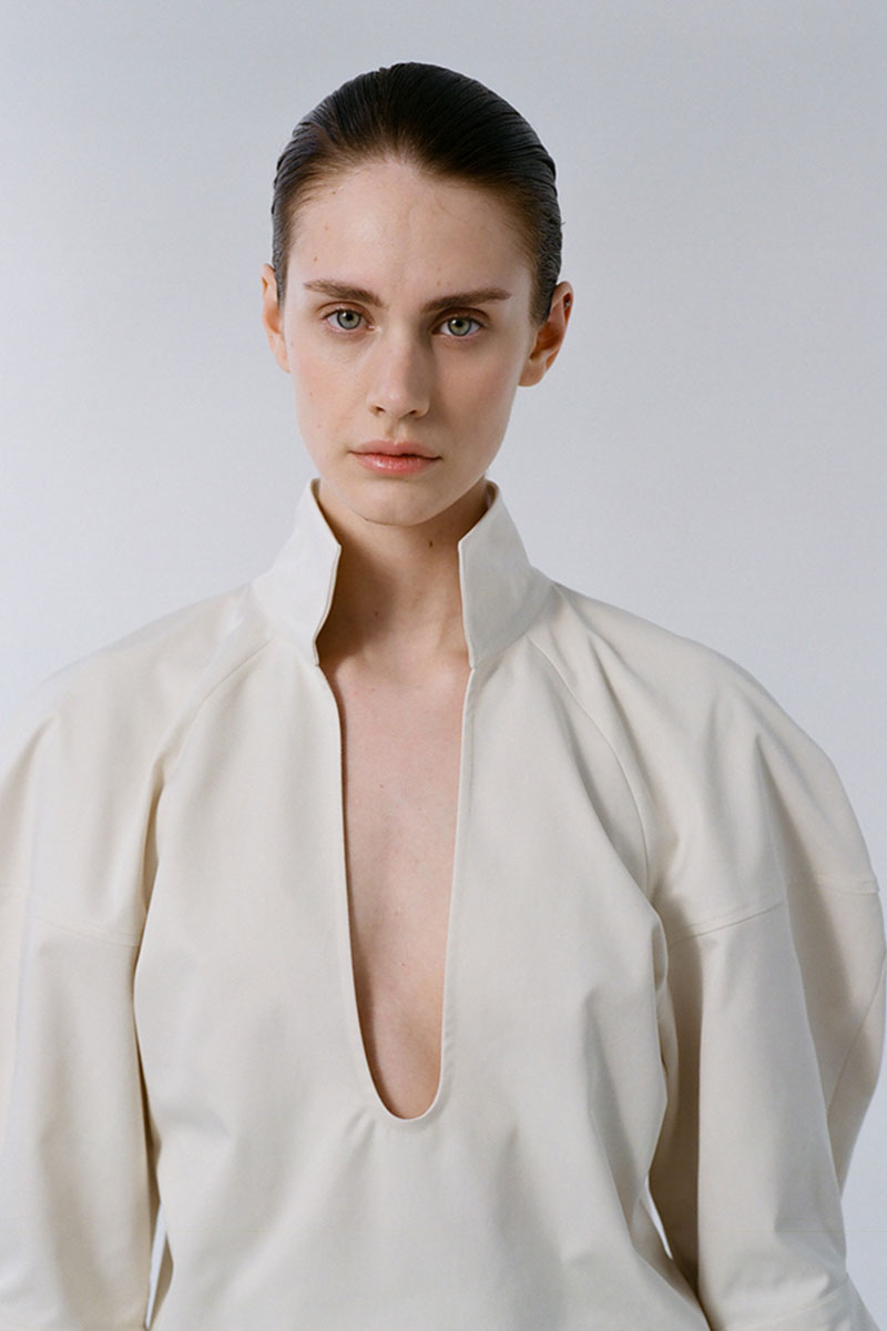 Gray-beige structure shirt by DELEGAN, featuring a tailored fit and subtle texture, displayed on a model in a campaign setting.