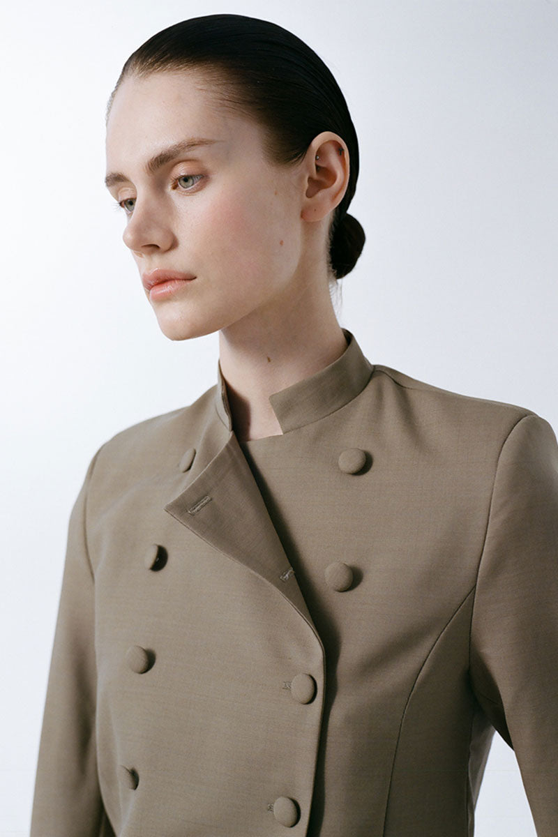 Delegan crop wool blazer on model, tailored fit with lapel collar and button closure, perfect for smart-casual styling.